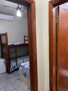 a door leading to a room with a bed and a room with a room at Pousada Sol Nascente in Olímpia +186 photos