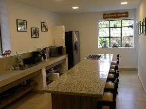 a kitchen with a counter and a sink and a counter top at Hacienda Rosas Pamba in Otavalo