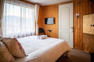 Postel nebo postele na pokoji v ubytování Hostal Lejana Patagonia