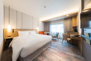 Postel nebo postele na pokoji v ubytování Hotel Metropolitan Edmont Tokyo