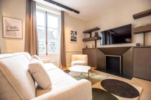 a living room with a couch and a tv at MBM - Luxury home in marais in Paris