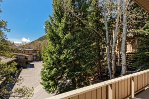 a view from the balcony of a house with trees at Deluxe Three Bedroom - Aspen Alps 209 in Aspen