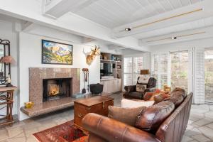 a living room with a couch and a fireplace at Deluxe Three Bedroom - Aspen Alps 201 in Aspen