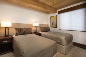 a bedroom with two beds and a window at Premier 2 Bedroom - Aspen Alps #104 in Aspen