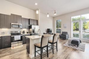 a kitchen and living room with a table and chairs at StayOvr at Galatyn Park in Richardson