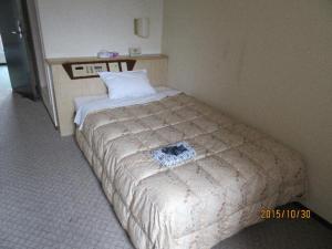 Un pat sau paturi într-o cameră la パーク琴芝