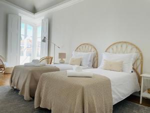 Ένα ή περισσότερα κρεβάτια σε δωμάτιο στο Casa Soure Suites and Apartments