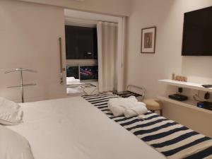 En eller flere senger på et rom på Residencial Portal da Barra