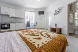 a kitchen with a large bed in a room at Apartment STUDIO in Novi Vinodolski