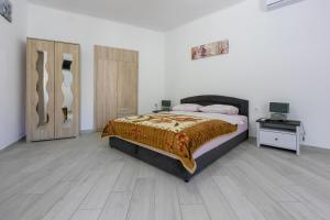 a bedroom with a bed and a table with a television at Apartment STUDIO in Novi Vinodolski