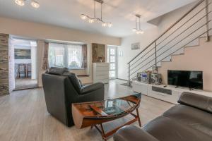 a living room with a couch and a table at House RUZICA in Novi Vinodolski