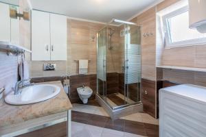 a bathroom with a shower and a sink and a toilet at House RUZICA in Novi Vinodolski +17 photos