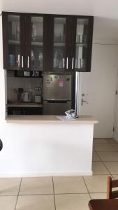 a kitchen with a stainless steel refrigerator and cabinets at Departamento por día ARICA in Arica