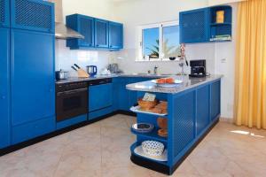 a blue kitchen with blue cabinets and a counter top at Holiday Home Praia da Luz - ALG01376-F in Mato Porcas