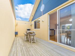 a house with a skylight and a table and stools at The Sails 8 in Inverloch