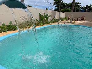 a water fountain in a swimming pool at Pousada Alma Noronha in Fernando de Noronha