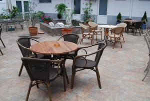 a group of tables and chairs in a patio at Hotel Maria in Constanţa