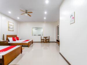 a bedroom with two beds and a ceiling fan at OYO 805 La Belladoza in Manila