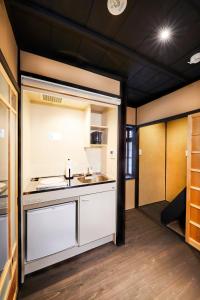 a kitchen with a sink and a counter in a room at Rinn Shijo Takase River North in Kyoto