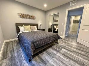 a bedroom with a bed and a walk in closet at Newly Built Townhouse - Prime Hollywood Location in Los Angeles