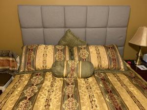 a bed with a head board and pillows on it at Private Guest Bedroom - 2E East Room - Close to Lake Michigan in Sheboygan