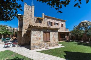 an external view of a stone house with a tower at Stone House Messinia in Málta