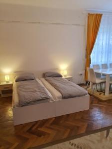 a bedroom with a bed and a desk and a table at Apartament Enescu in Timişoara