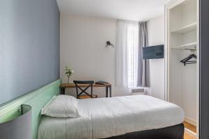 a small room with a bed and a table at Atlantic Hotel Rennes Centre Gare in Rennes