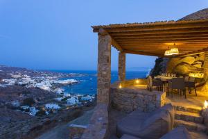 a restaurant with a view of a city at night at Villa Azurite with heated pool by Diles Villas in Psarou