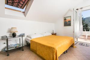 a bedroom with a bed and a window at Apartments Tramonto in Zaton +9 photos