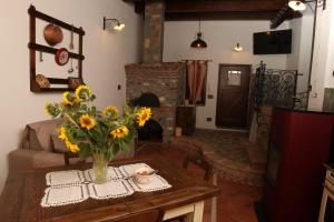 a living room with a vase of flowers on a table at Villa Manca in San Severino Lucano