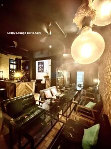 a living room with couches and a table and lights at Kim Haus Loft in George Town