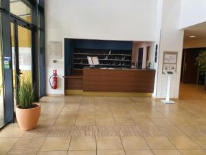a lobby of a building with a fire extinguisheracistacistacistacist at Domitys Les Rives du Cher in Montluçon