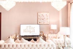 a living room with a white couch and a tv at Elite Royal Apartment - Full Burj Khalifa & Fountain View - Sapphire in Dubai