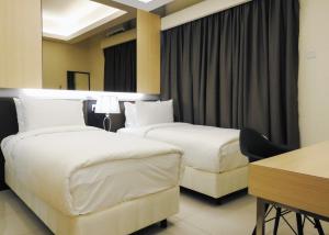 a hotel room with two beds and a desk at Grand Ion Delemen Hotel in Genting Highlands