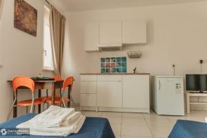 a kitchen with a table and a refrigerator at Residence Le Stelle in Campolungo