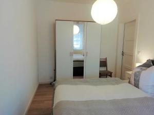 a bedroom with a mirror and a bed and a chair at Ferienwohnung Ahrens in Hoyerswerda