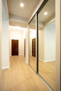 een lege kamer met glazen deuren en houten vloeren bij Двух комнатная квартира в центре in Nikolayev