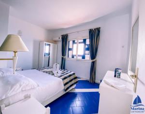 a hotel room with a bed and a window at Marina Cap Monastir- Appart'Hôtel in Monastir