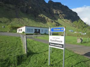 a sign that is on the side of a road at South Iceland Guesthouse in Steinar