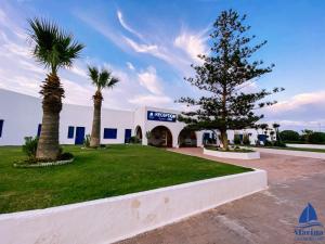 a christmas tree in front of a building at Marina Cap Monastir- Appart'Hôtel in Monastir