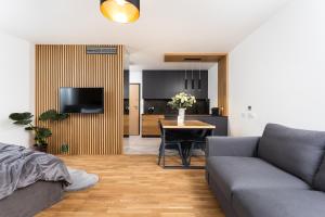 a living room with a couch and a table at InPoint Smart Apartments in Krakow