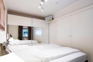 1 dormitorio con 2 camas y espejo en Miramar Relax, en Grömitz