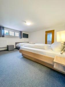 a large bedroom with two large beds in it at Mountain Hostel City in Oberstdorf