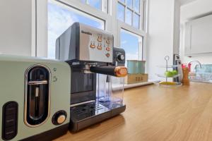 a coffee maker sitting on top of a kitchen counter at SkyView Eastbourne 24 in Eastbourne