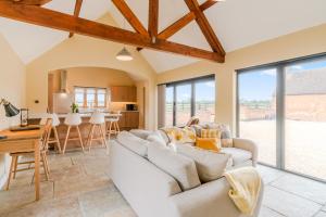 a living room with a white couch and a table at Swifts Retreat in Bidford