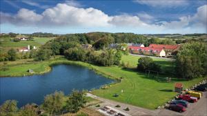 an aerial view of a town with a lake at Volstrup Apartments in Stenild