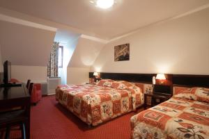 Postel nebo postele na pokoji v ubytování Hostellerie St Vincent