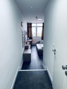 a hallway with a living room with a couch at Hotel Terminal One in Sindelfingen