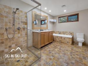 a bathroom with a shower and a sink and a toilet at On The Snow 1 in Thredbo